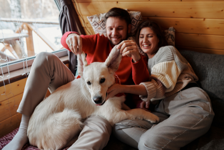 Couple smiling with their dog