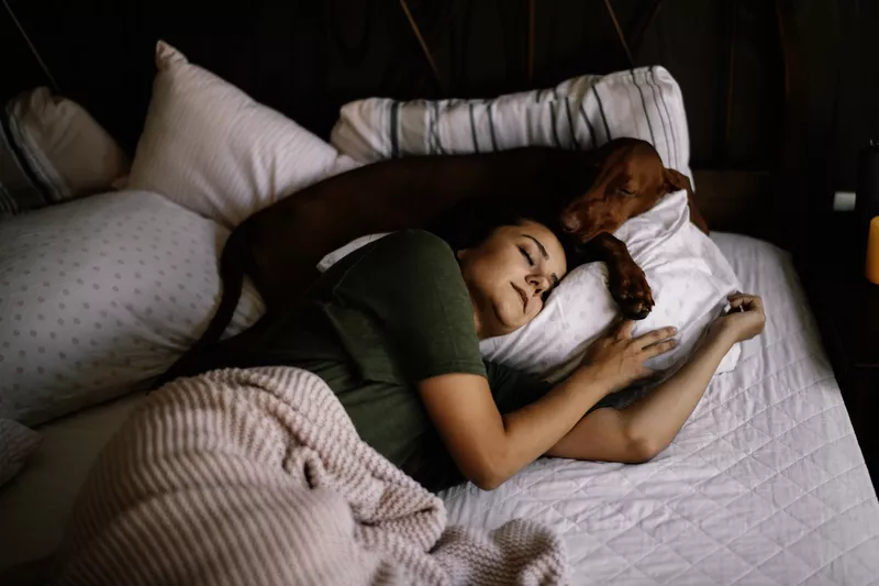 Girl sleeping with her dog