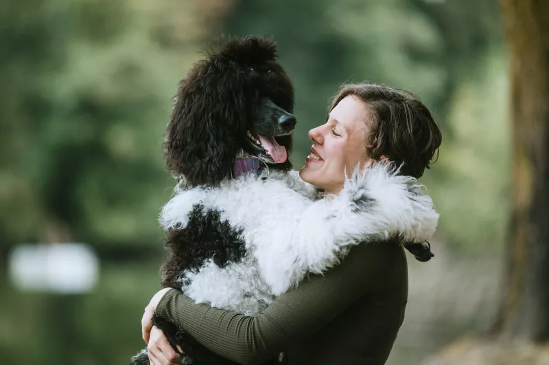 Young Woman Spending Quality Time With Her Dog Outside