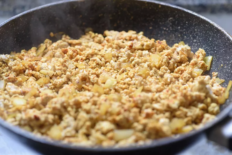 Preparing Ground meat stir fry with onion and spices in frying pan.Selective focus