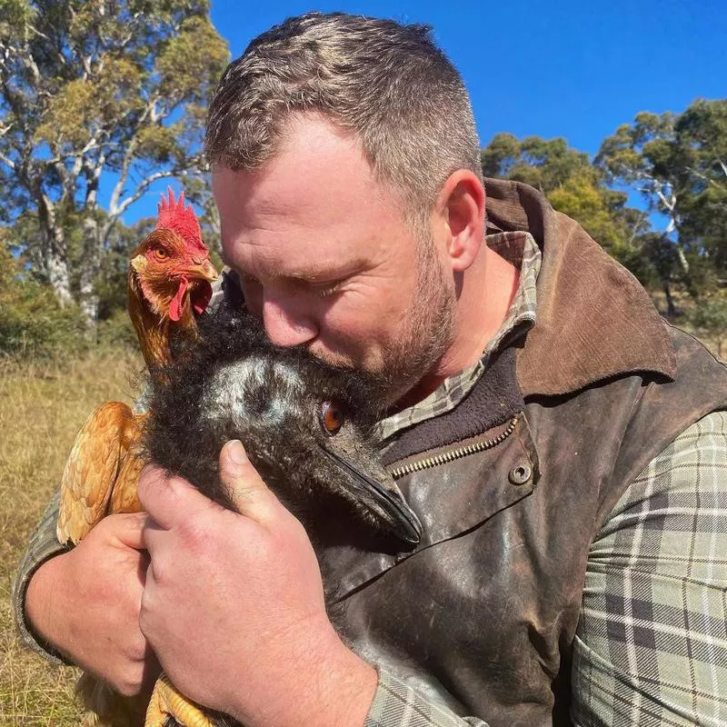 Man with pet emu and chicken