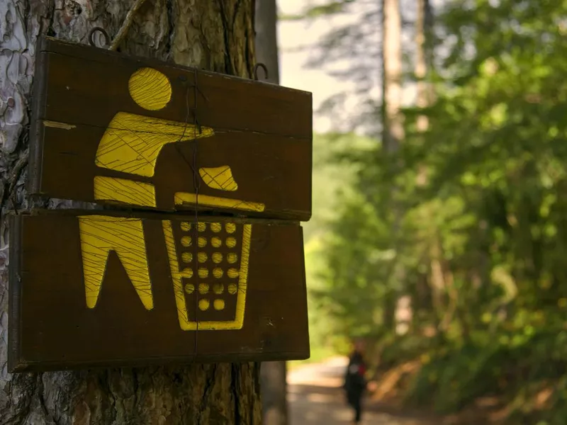 trash sign in woods