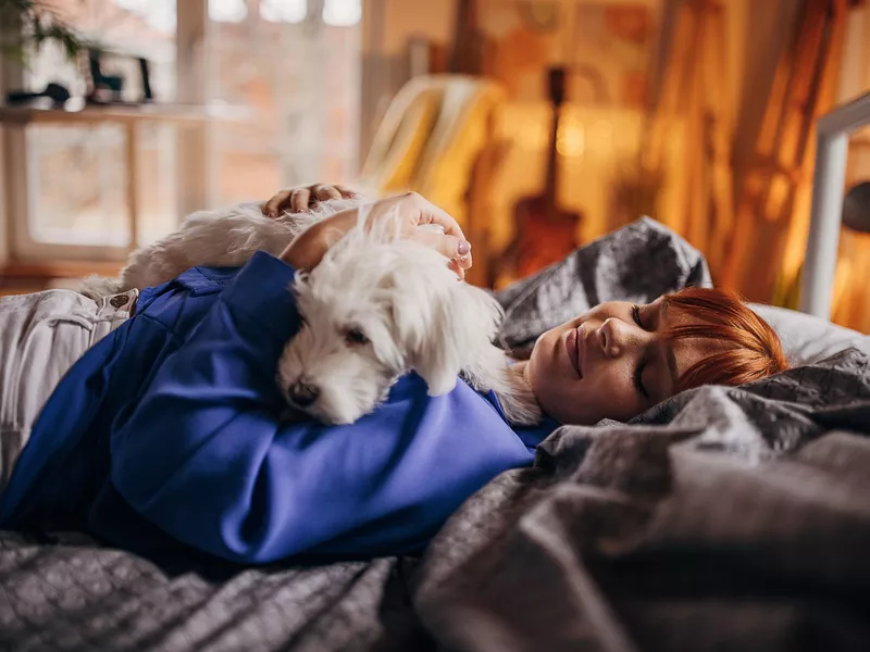 Woman napping with dog