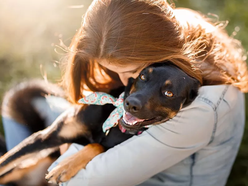 Girl hugging her dog