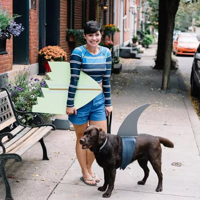 A Surfer and a shark dog and human costume