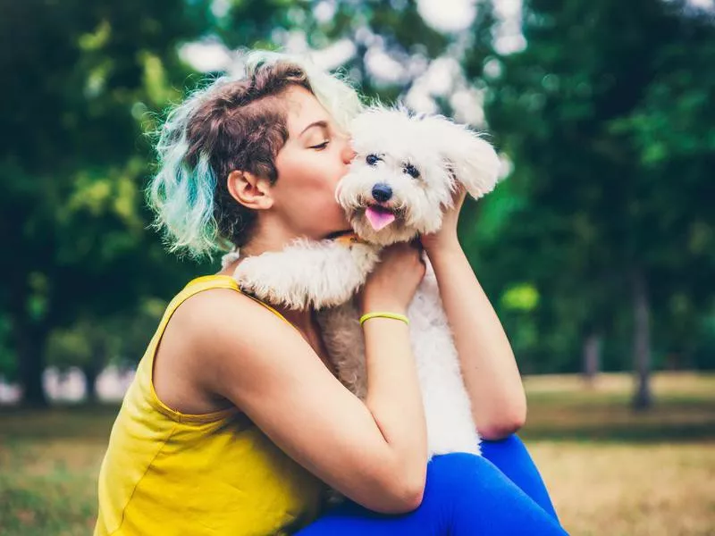 Woman kissing dog