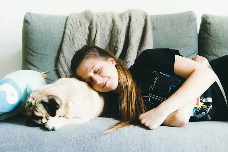 woman and pug sleeping