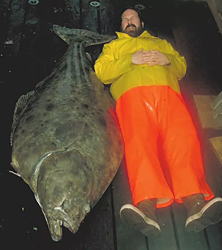 Fisherman Lying Next to Halibut